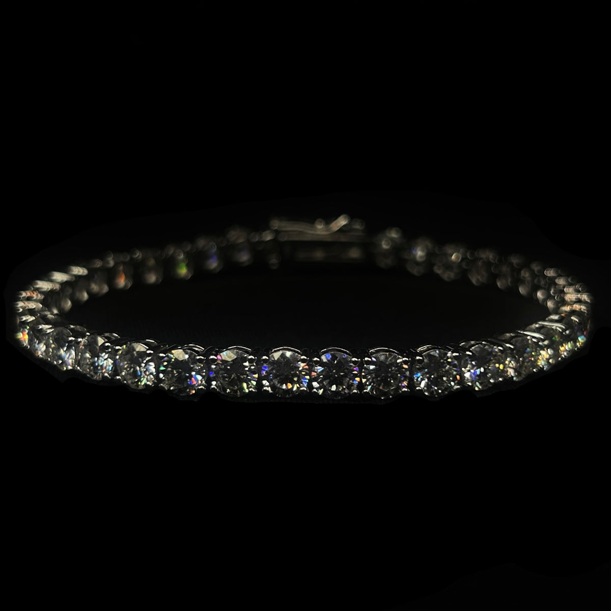 Diamond bracelet on a black background with 'CRUDDA.' branding.