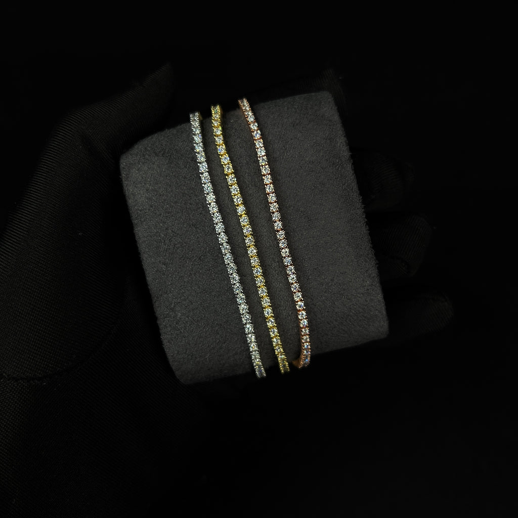 Two diamond bracelets on a black stand against a dark background