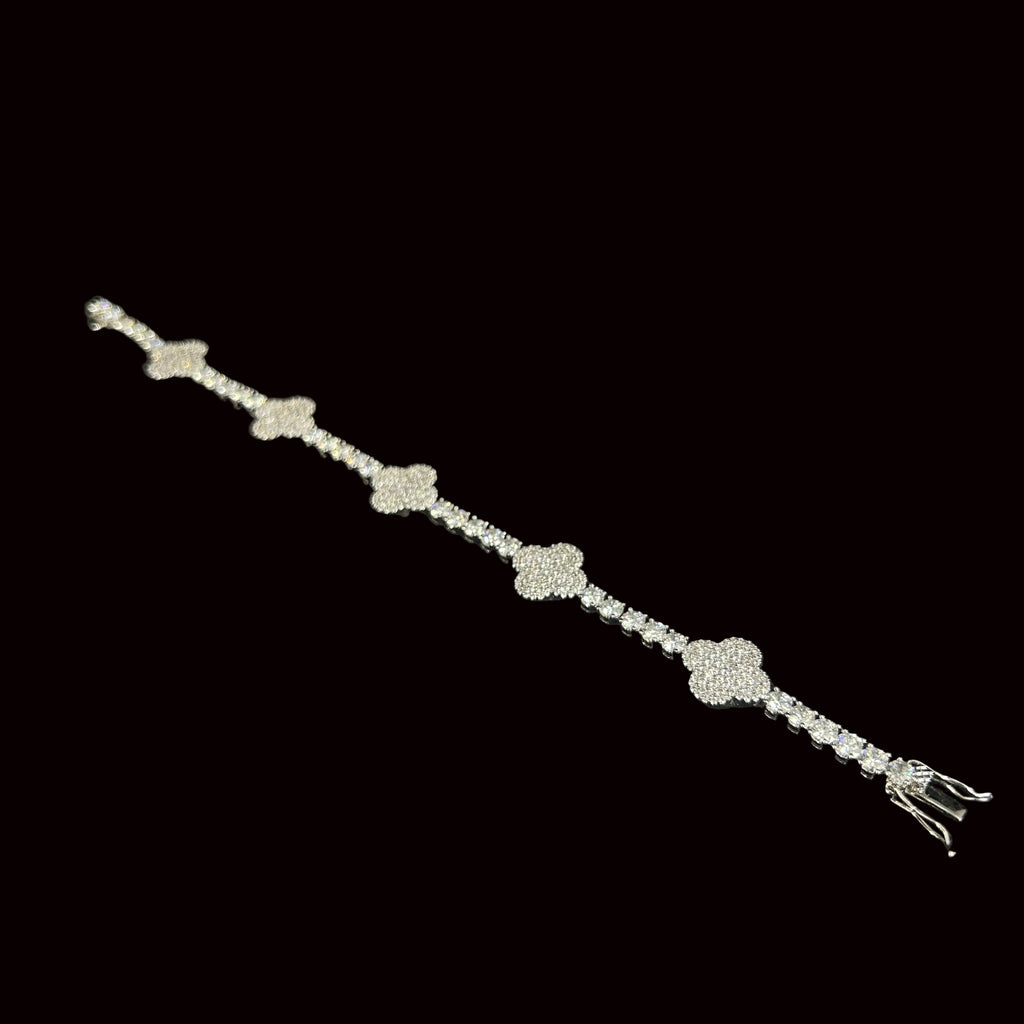 Silver bracelet with floral designs on a black background