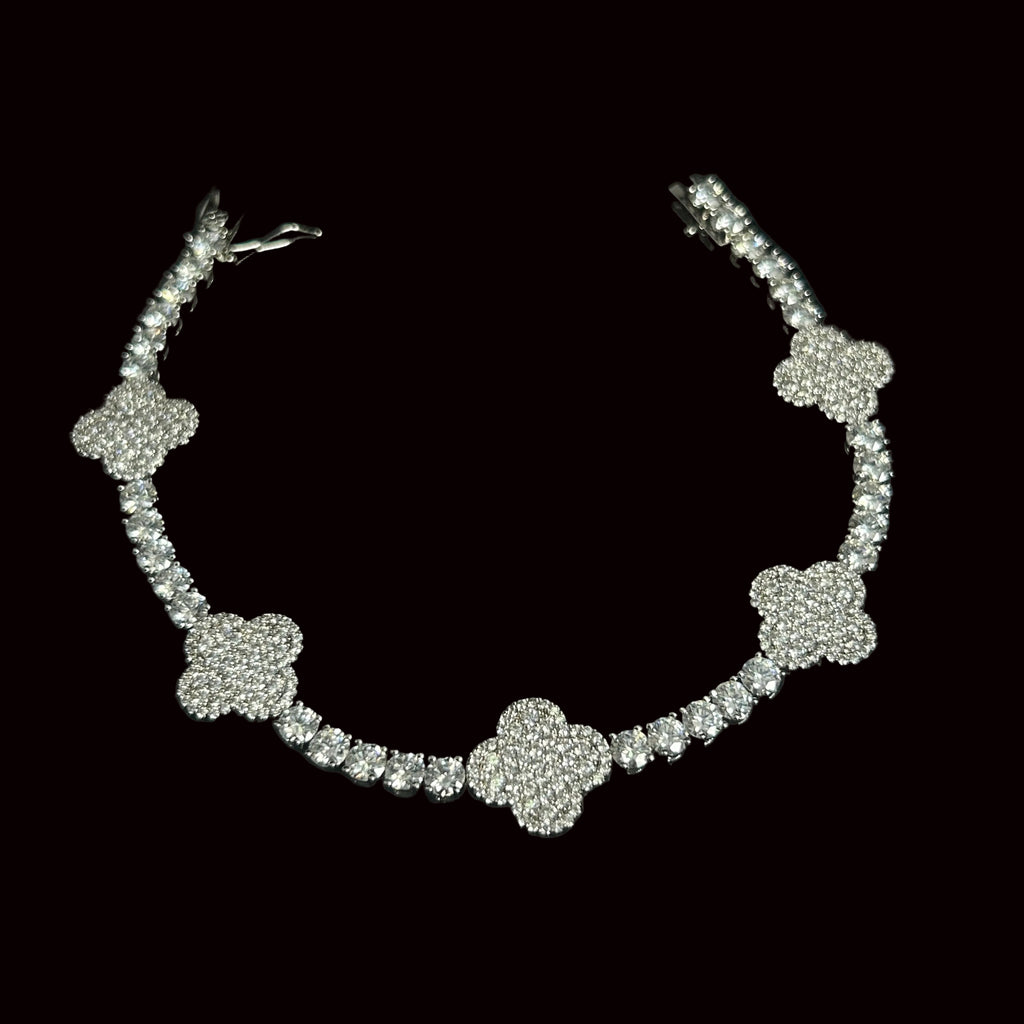 Silver necklace with floral designs on a black background