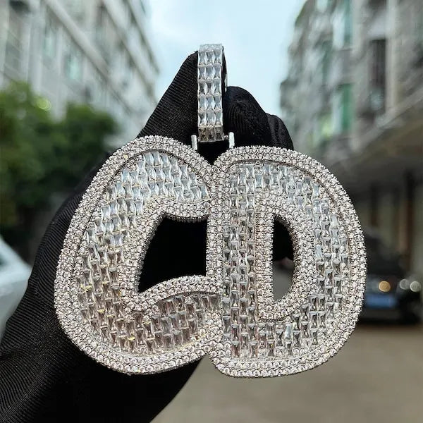 Large diamond-studded earrings held against a blurred urban background